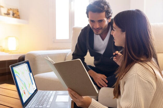 Close-up of people working from home on laptops in a modern workspace.