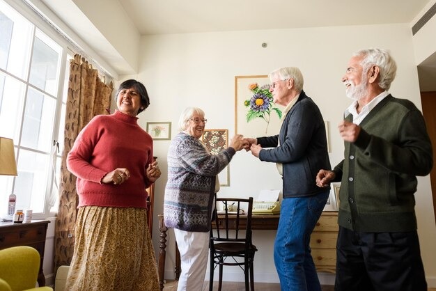 Assisted Living for Seniors: Enjoy a Safe, Fulfilling Life 3 Seniors dancing joyfully in a bright living room, enjoying music and each other, showing an active, social retirement life.